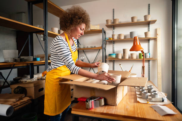 istock Small business owner packing her products for delivery 1288667220