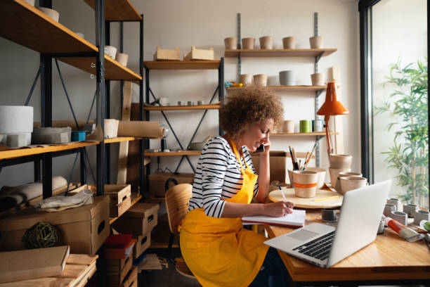 Small business owner accepting new orders from customers by smartphone
