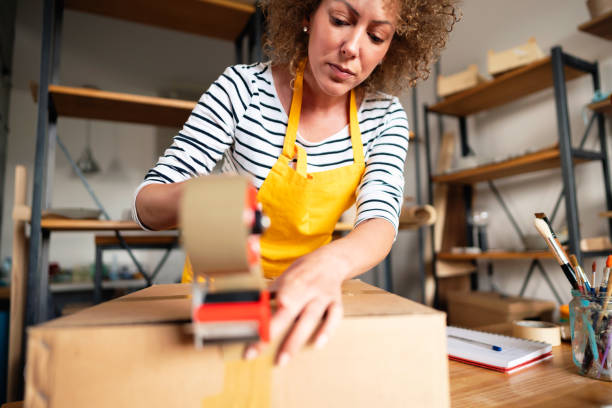 istock Caucasian ethnicity entrepreneur packing products for a delivery 1288667308