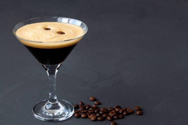 espresso martini cocktail garnished with coffee beans on dark table. martini glass on a black background. alcohol drinks. copy space. top view - breakfast cup coffee hot drink imagens e fotografias de stock