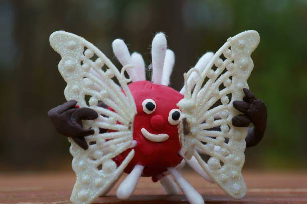 istock A plasticine virus figurine holds a broken butterfly in its hands. 1288667749