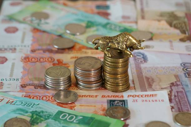 istock Metal bull with coins on the table. 1288667823