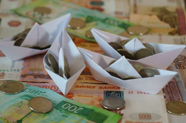 istock Several paper boats loaded with coins. 1288667827