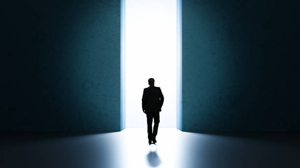 istock Man walking through light to a better world leave behind all sorrows - 3D Illustration 1288668706