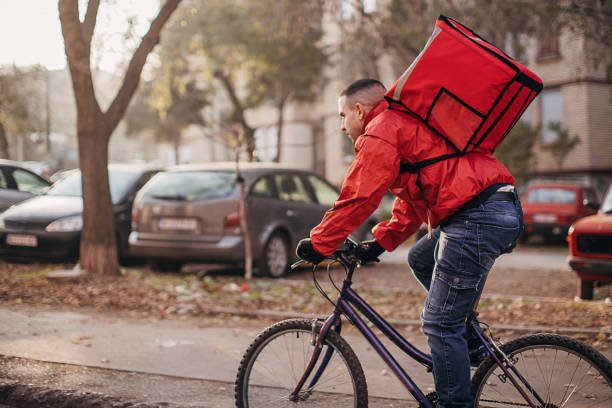 istock Man doing food delivery on bicycle 1288669052