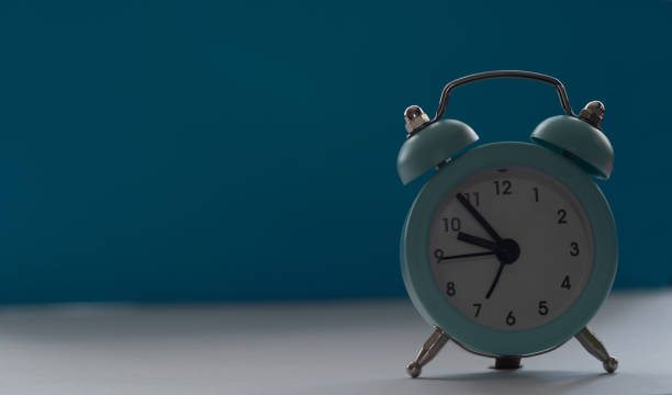 istock Alarm clock on a blue background Place for text 1288669139