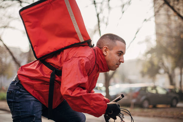 istock Man doing food delivery on bicycle 1288669276