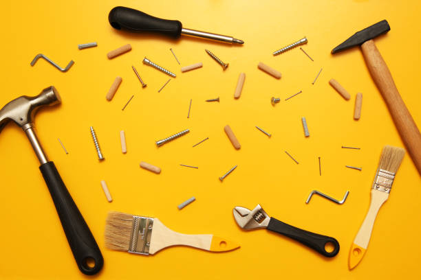 Construction materials hammer nails on a yellow background Construction materials hammer nails on a yellow background. all tool isolated screwdriver photos stock pictures, royalty-free photos & images