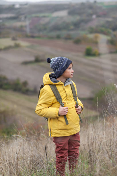 istock Little hiker during autumn day on a hill. 1288672470