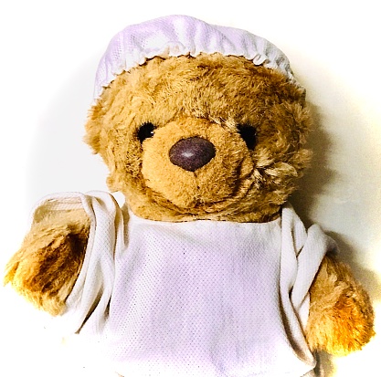 Healthcare and Medical Concept, Teddy Bear Wearing Medical Facemask and Doctor Uniform.