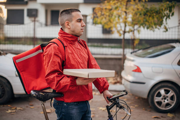 istock Man doing pizza delivery with bicycle in city 1288682188