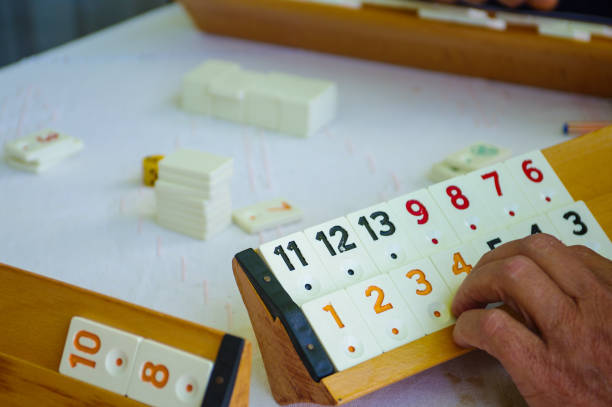 istock Men Playing Traditional Turkish Okey Game With Color Chips On The Game Table 1288686579