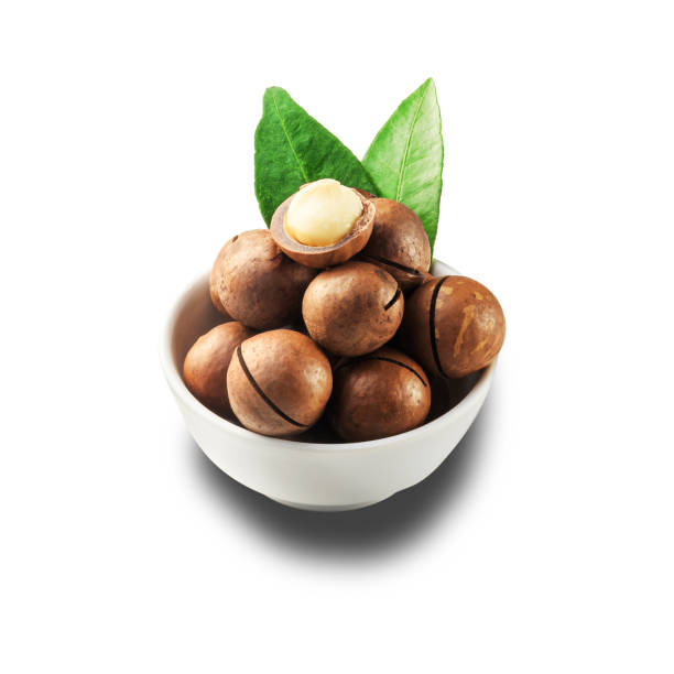istock Macadamia nut in a white bowl against a white isolated background. 1288688719
