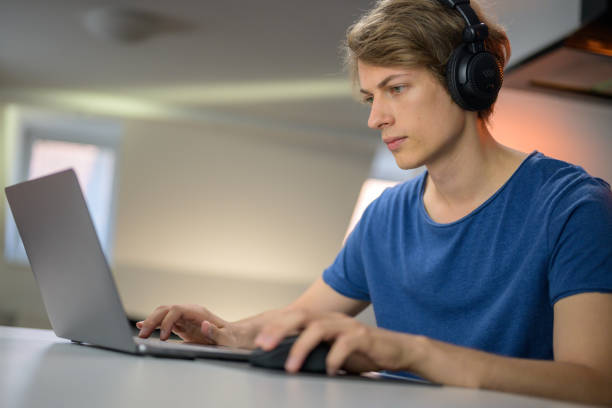 istock Teenage boy attending online school classes from home 1288690324