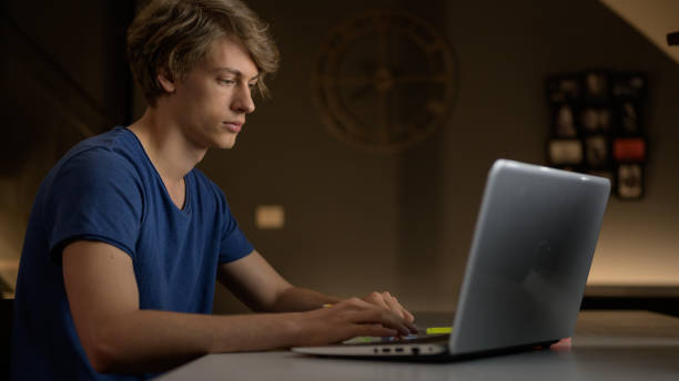 istock Teenage boy attending online school classes from home 1288690470