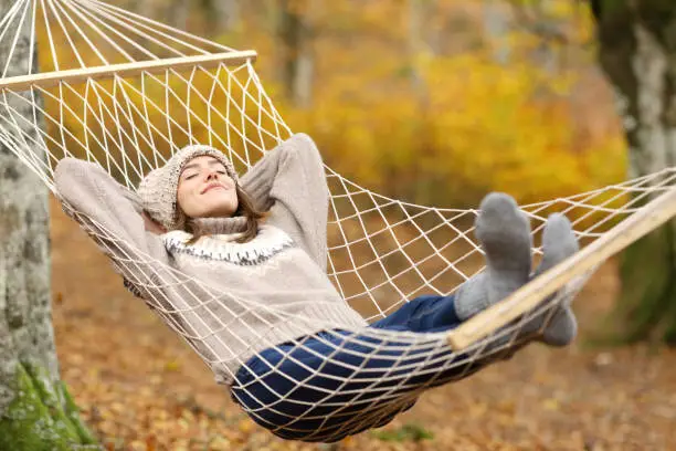 Photo of Relaxed woman resting on hammock in autumn holiday