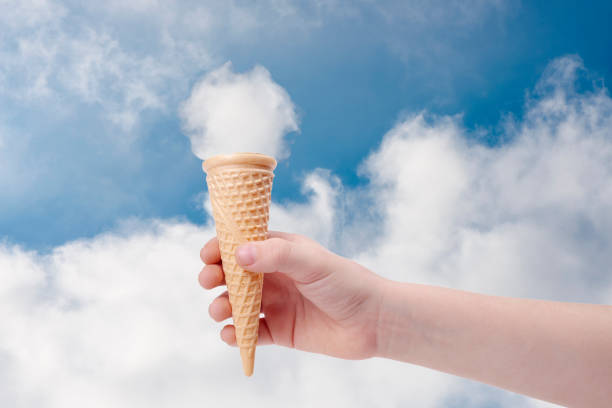 istock Child Hand Holding Ice Cream Cone With Fluffy Cloud 1288691666
