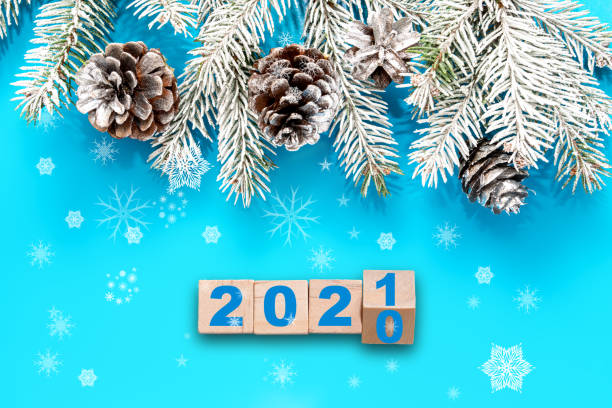 istock Blue Christmas background, frame with fir branches, and silver decorations. The concept of changing the year from 2020 to 2021 1288691956