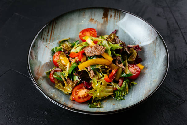 istock warm salad with marbled beef steak on a black background 1288692063