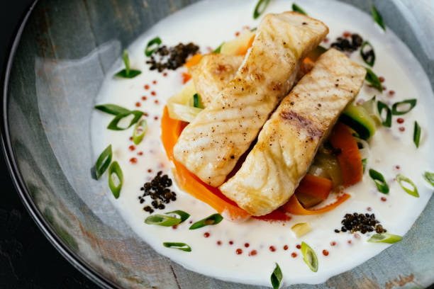 istock grilled cod fillet with vegetables and sauce on a black backgrou 1288692268