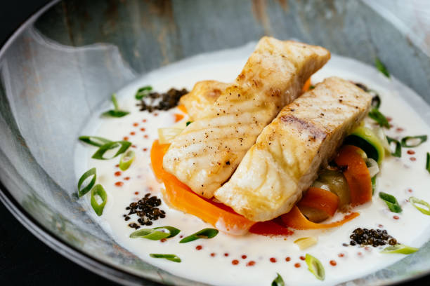istock grilled cod fillet with vegetables and sauce on a black backgrou 1288692274