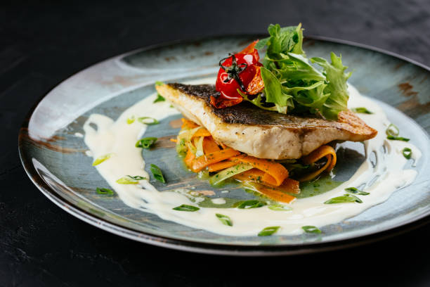 istock grilled cod fillet with vegetables and sauce on a black backgrou 1288692277