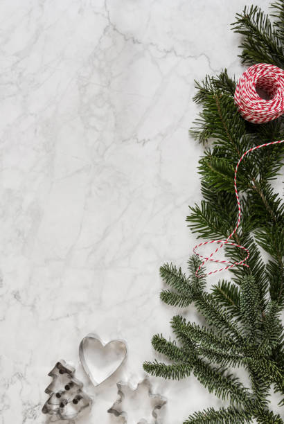 Christmas background with pinaceae branches and cookie cutters