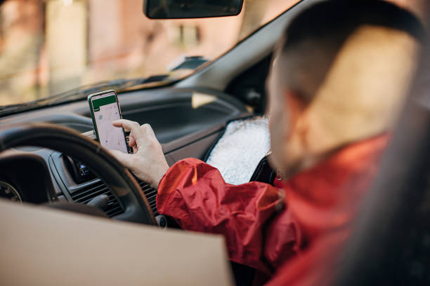 istock Pizza delivery man using smart phone in a car 1288692775