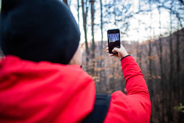 istock Hiking man taking a photo from winter hiking session 1288694093