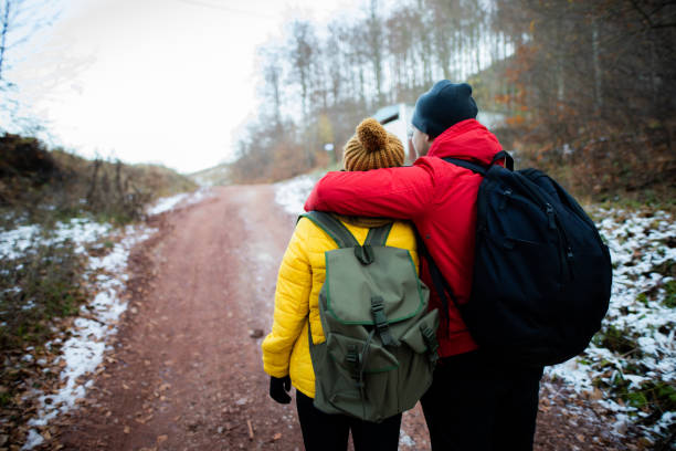 istock Embraced couple walking trough the forest 1288694241