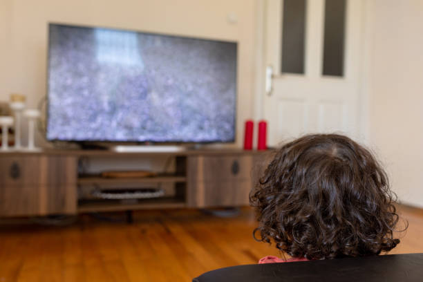 istock Little boy watching tv sitting at home 1288702245