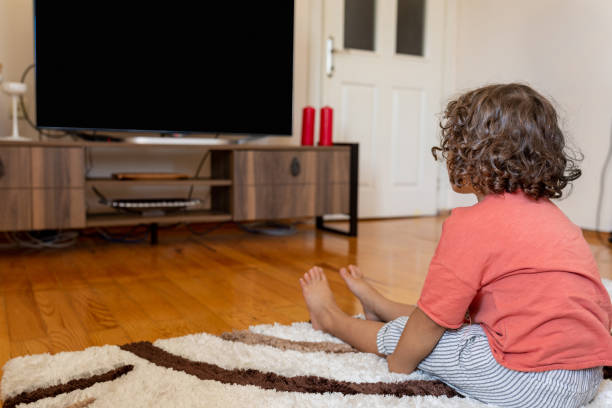 istock Little boy watching tv sitting at home 1288702334