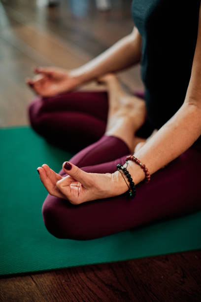 istock A middle-aged woman doing yoga, following an online tutorial on laptop during corona virus pandemic. 1288702479