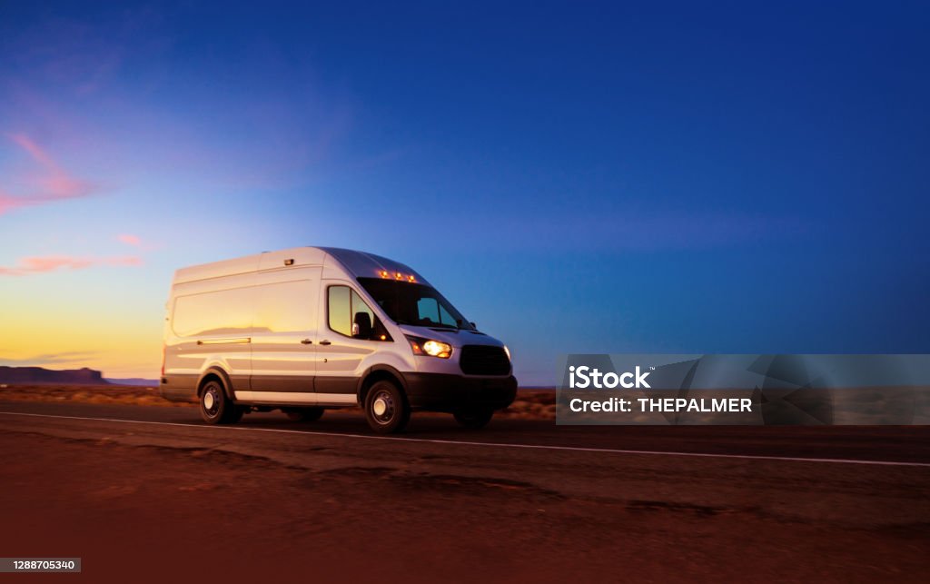 White delivery van driving on rural road in Monument Valley Arizona Van - Vehicle Stock Photo