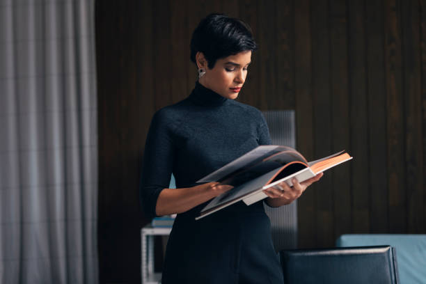 istock At a Design Studio: an Interior Designer Consulting a Book While Working at her Airy Office 1288707115