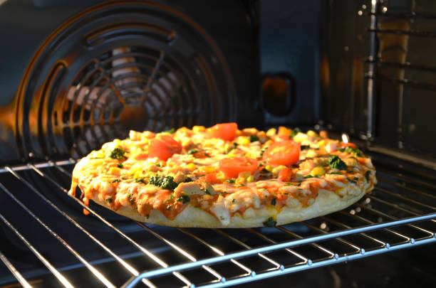istock Tasty pizza with cheese and tomatoes cooked in the oven 1288707155