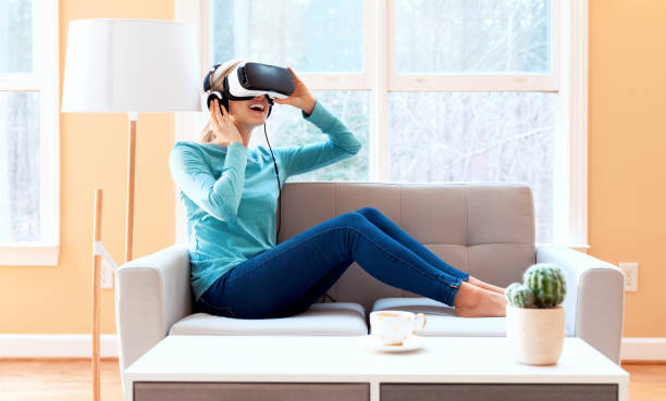istock Happy young woman using a VR headset 1288707416