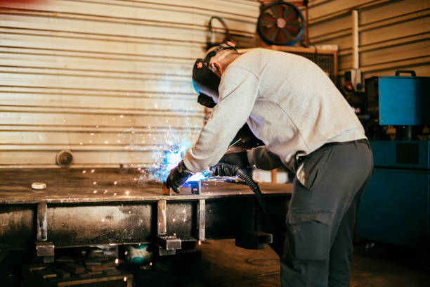istock Senior worker in the factory operating machines 1288709104