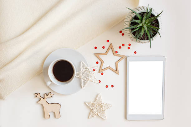 istock A digital tablet with a blank screen, lies on a white table surrounded by flat wooden Christmas decorations 1288711362