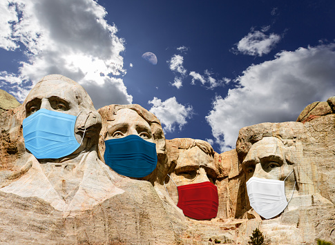 Mount Rushmore with the presidents wearing a mask due to covid-19