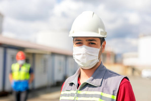istock Worker is using a protective face mask for coronavirus and looking at the camera in the construction site. The group of viruses cause respiratory tract infections that can range from mild to lethal. 1288711918