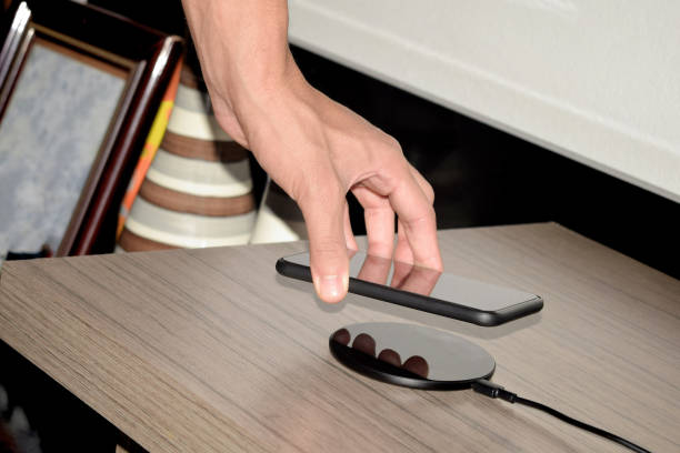istock Placing a mobile phone in a wireless charger 1288714937