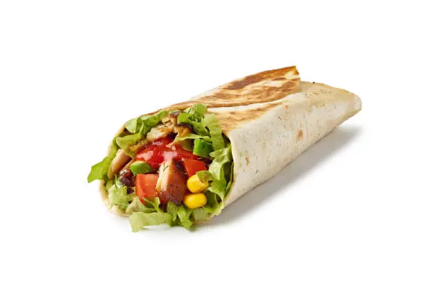 Tortilla wrap with vegetables and fried chicken meat isolated on white background. Include clipping path