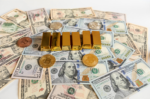 Gold bars ingot on US dollar bill banknotes background