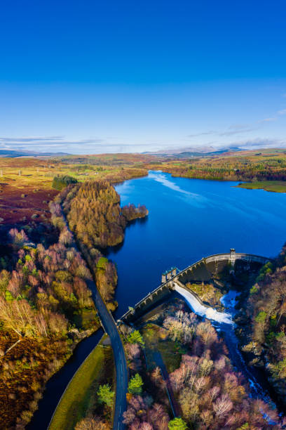 The aerial vertical panoramic view of a hydro electric dam on a Scottish loch in rural Dumfries and Galloway The view from a drone of a dam with it’s gates open on an autumn morning. The dam is part of a hydro electric generating scheme.
The panorama was created by merging several images together. Galloway Hills stock pictures, royalty-free photos & images