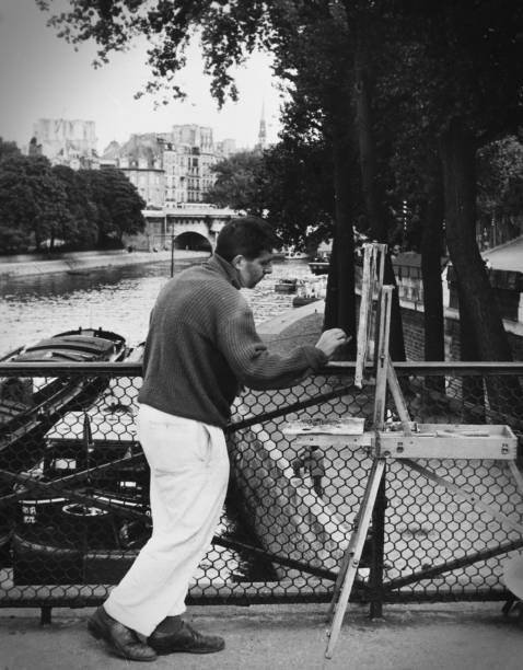 Cathedral of Notre Dame de Paris sunny autumn afternoon. Embankment of the Seine. The natives and tourists take a walk and relax in warm weather. Blurred unrecognizable faces. BW photo. Paris. France.