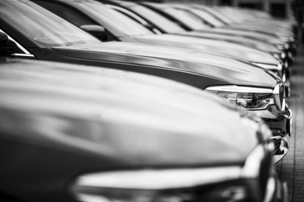 A row of used BMW cars parked at a public car dealership in Hamburg, Germany Hamburg, Germany - November 29. 2020: A row of used BMW cars parked at a public car dealership in Hamburg, Germany. Image developed as „black and white“ No people in this picture bmw dealership stock pictures, royalty-free photos & images
