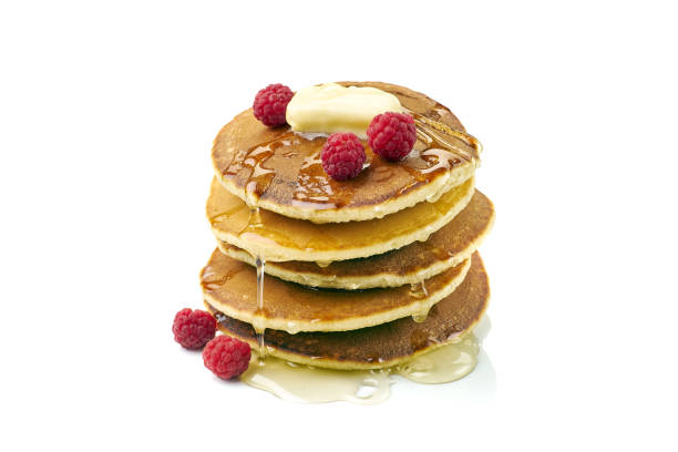istock Stack of pancakes with butter, honey and raspberries on white 1288723368