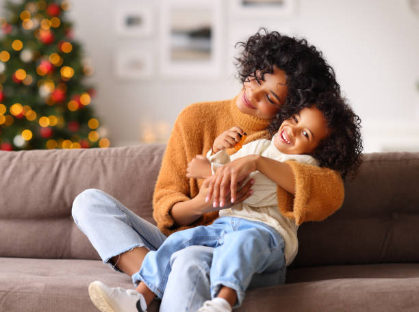 Mother and son playing on sofa on Christmas day