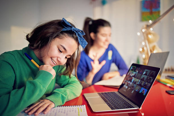 istock Two sisters are e-learning and video conferencing at home 1288724078